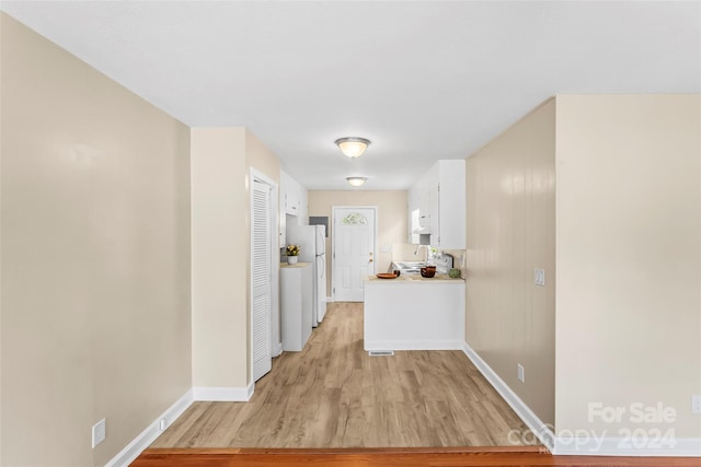 hall with light hardwood / wood-style flooring