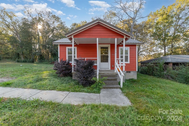 bungalow-style home featuring a front yard