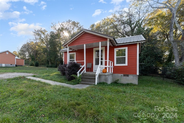 view of front of home with a porch and a front yard