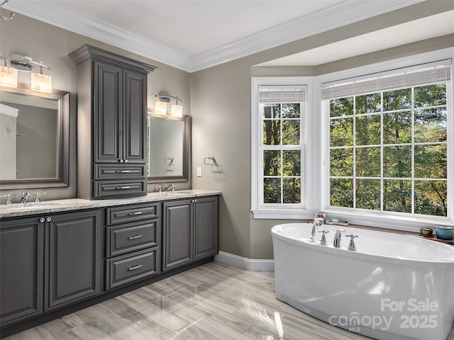 full bathroom with a sink, a soaking tub, double vanity, and crown molding