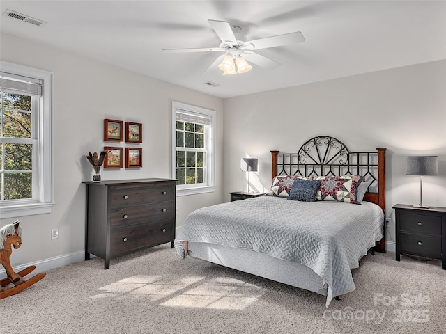 bedroom with visible vents, baseboards, a ceiling fan, and carpet flooring