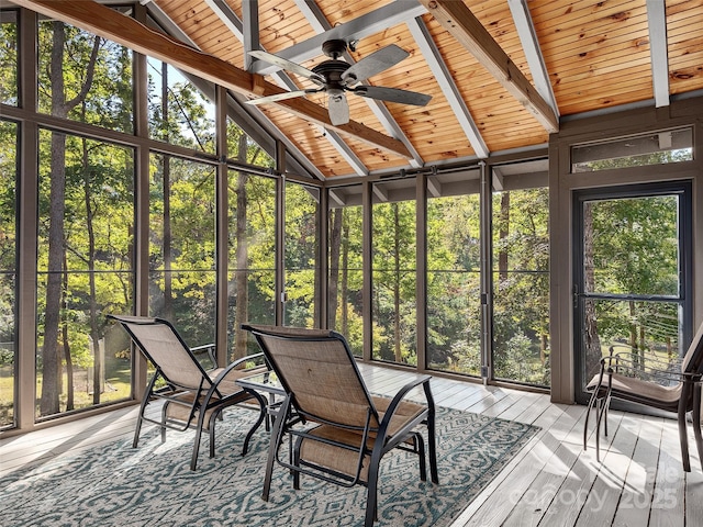 unfurnished sunroom featuring wood ceiling, lofted ceiling with beams, and ceiling fan