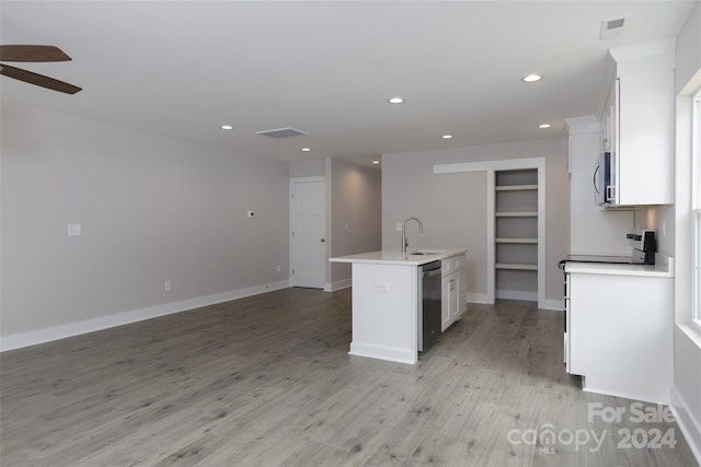 kitchen featuring white cabinets, light hardwood / wood-style floors, stainless steel appliances, and a center island with sink