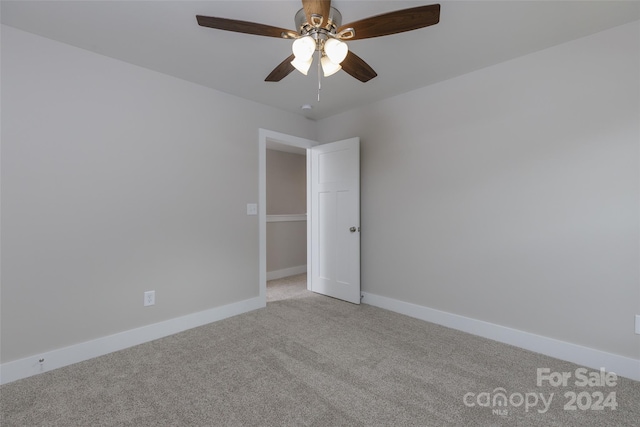 unfurnished room featuring light colored carpet and ceiling fan