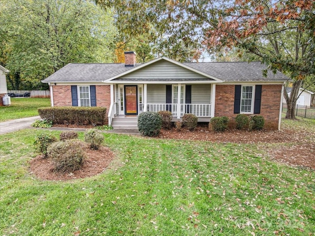 ranch-style house featuring a porch and a front yard