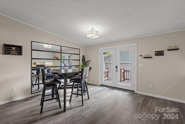 dining room featuring a textured ceiling, crown molding, hardwood / wood-style floors, and french doors