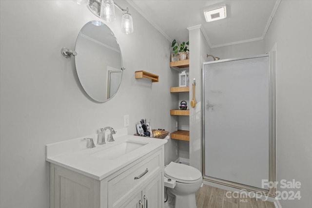 bathroom featuring crown molding, toilet, a shower with shower door, and wood-type flooring