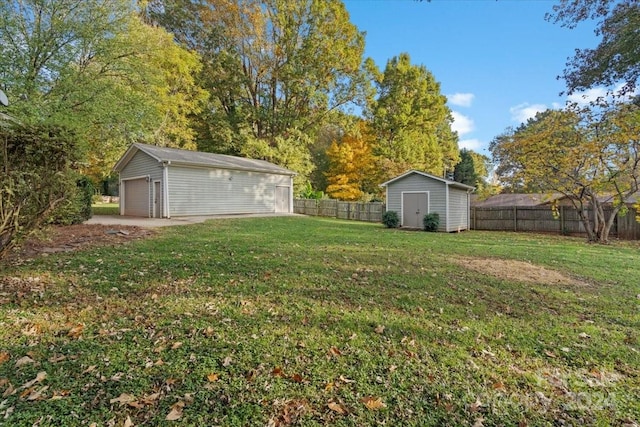 view of yard with a garage and a storage shed