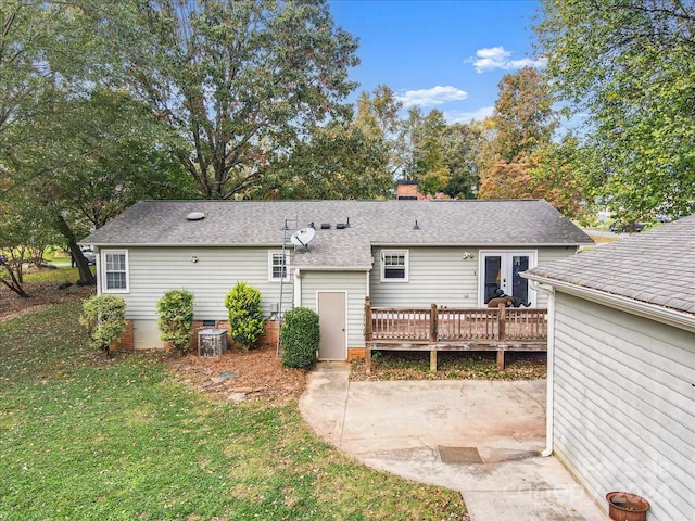 rear view of property with a lawn, central AC, a patio area, and a deck