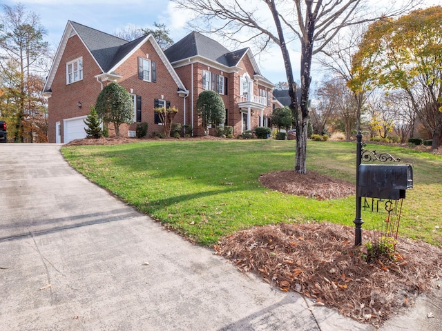 front facade featuring a front yard and a garage