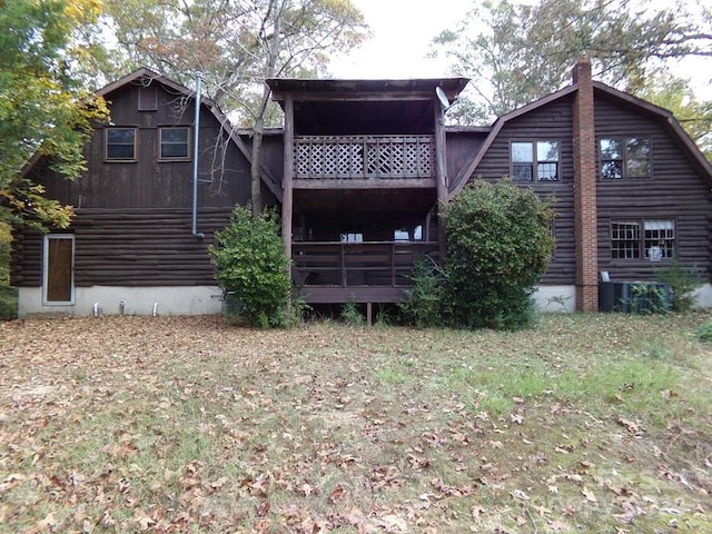 back of house featuring a balcony