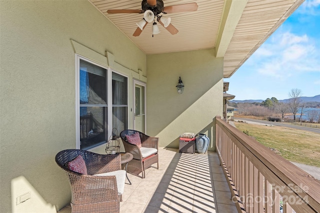 balcony with a mountain view and ceiling fan