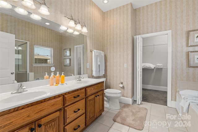 full bathroom featuring vanity, shower with separate bathtub, toilet, and tile patterned floors