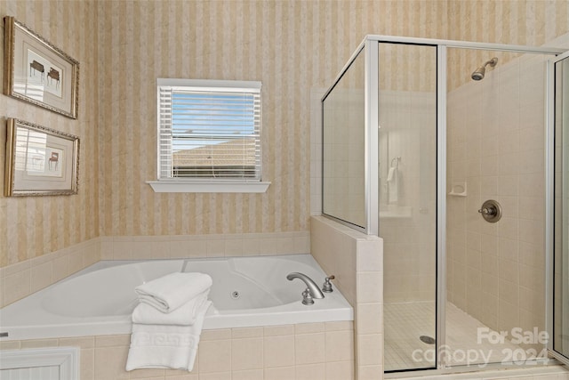 bathroom with shower with separate bathtub