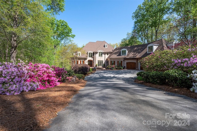 cape cod home with a garage