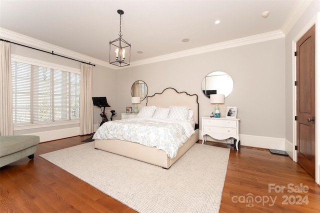 bedroom with ornamental molding, wood-type flooring, and a notable chandelier