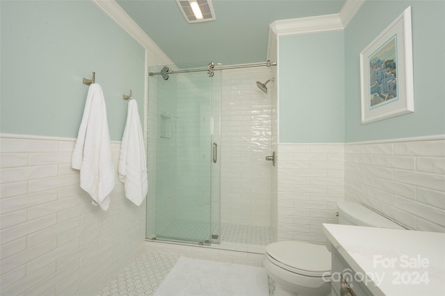 bathroom with toilet, a shower with door, tile walls, ornamental molding, and vanity