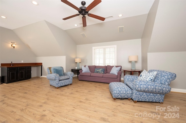 living room featuring ceiling fan, sink, light wood-type flooring, and vaulted ceiling