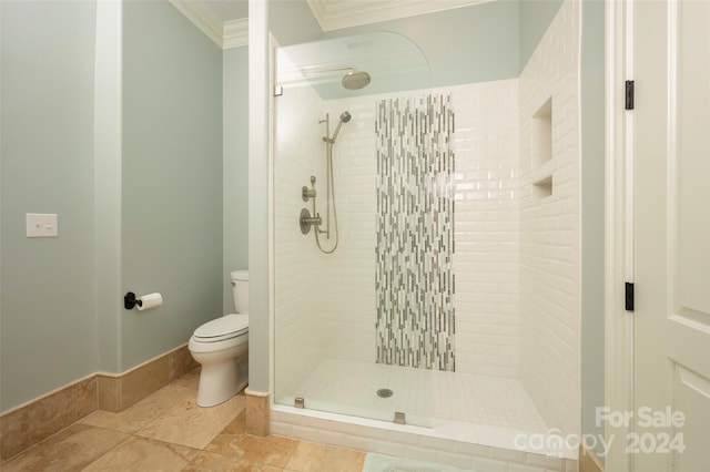 bathroom featuring crown molding, a tile shower, tile patterned flooring, and toilet