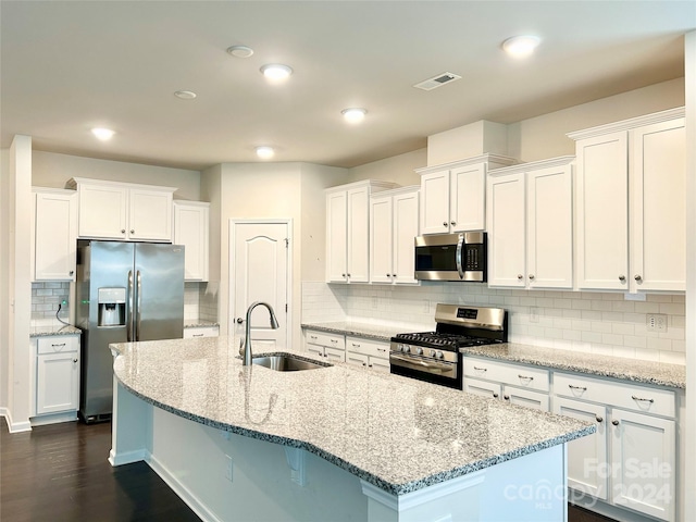 kitchen with sink, dark hardwood / wood-style floors, decorative backsplash, white cabinets, and appliances with stainless steel finishes