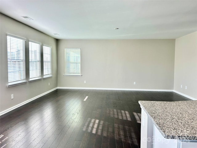 empty room with dark hardwood / wood-style floors