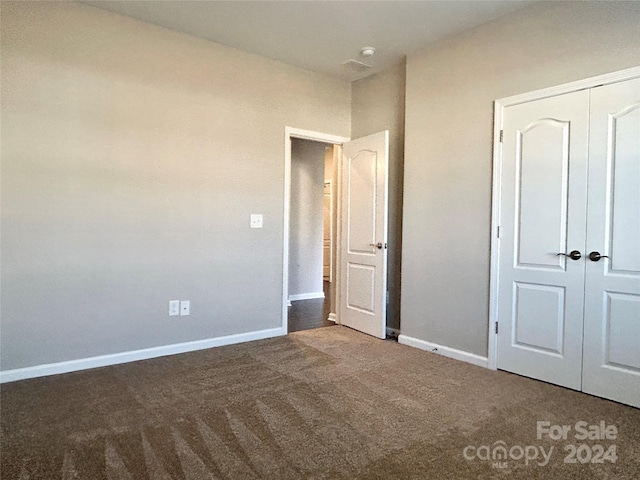 unfurnished bedroom with carpet floors and a closet