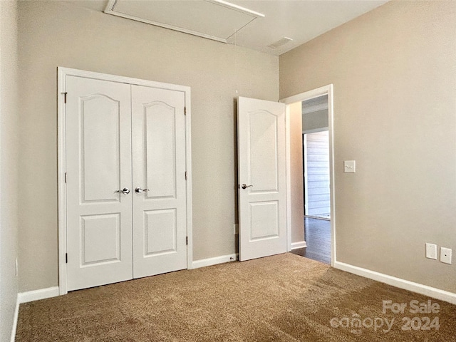 unfurnished bedroom with carpet flooring and a closet