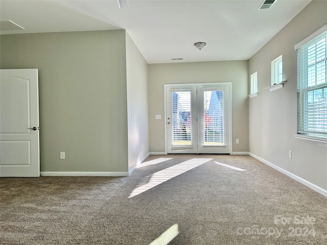 unfurnished room featuring light colored carpet