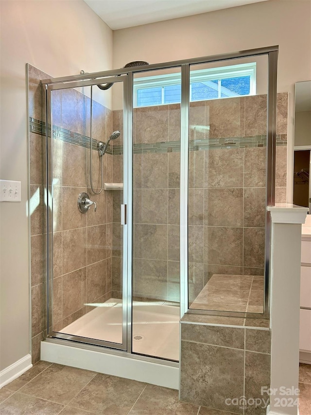 bathroom featuring a shower with door and tile patterned flooring