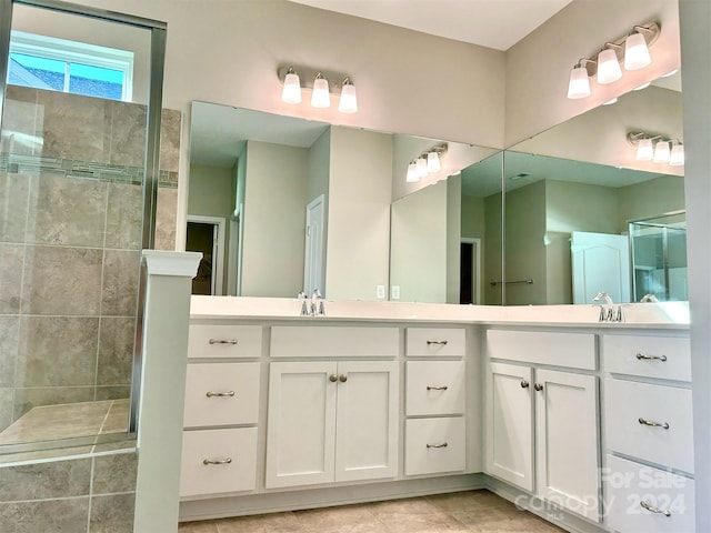 bathroom with vanity and tiled shower