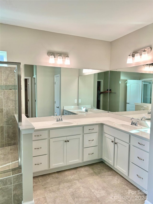 bathroom with vanity and a shower with door