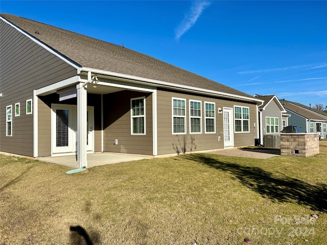 rear view of house featuring a patio, area for grilling, and a lawn