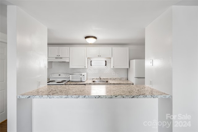 kitchen with white cabinetry, sink, backsplash, and white appliances