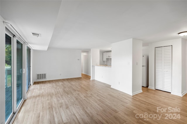 unfurnished living room featuring light hardwood / wood-style flooring