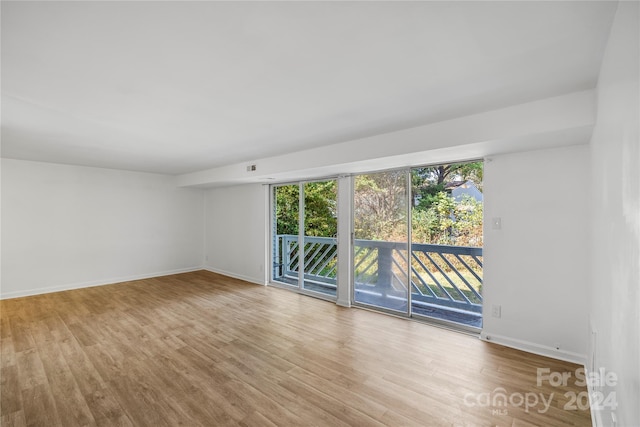 spare room featuring light wood-type flooring