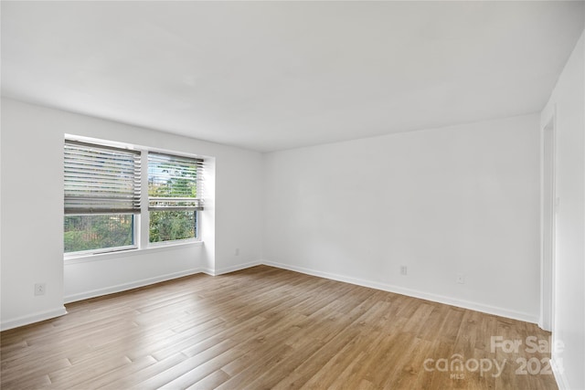 empty room with light hardwood / wood-style flooring