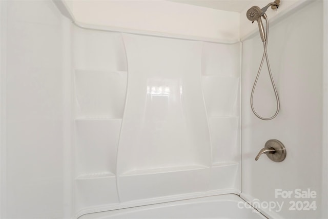 bathroom with bathing tub / shower combination