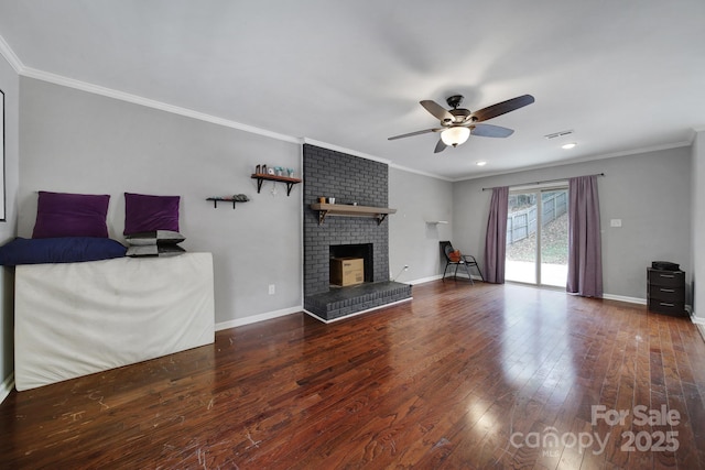 unfurnished living room with ornamental molding, a brick fireplace, ceiling fan, and dark hardwood / wood-style flooring