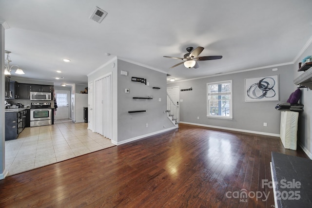 unfurnished living room with crown molding, hardwood / wood-style flooring, a wealth of natural light, and ceiling fan