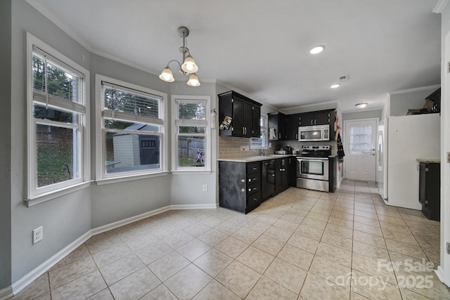 kitchen featuring crown molding, appliances with stainless steel finishes, and light tile patterned floors