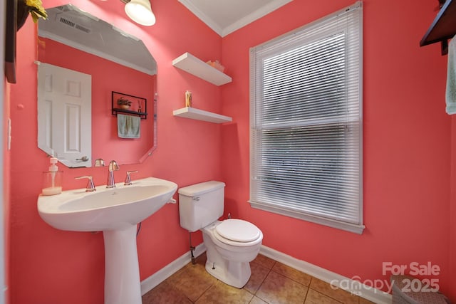 bathroom with crown molding, tile patterned floors, and toilet