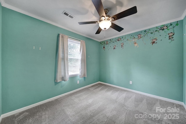 empty room with crown molding, carpet flooring, and ceiling fan