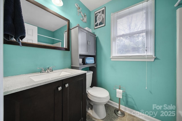 bathroom featuring vanity, walk in shower, tile patterned floors, and toilet