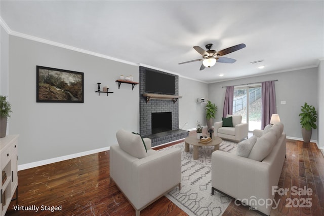 living room with crown molding, a brick fireplace, dark hardwood / wood-style floors, and ceiling fan