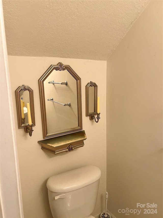 bathroom featuring a textured ceiling and toilet