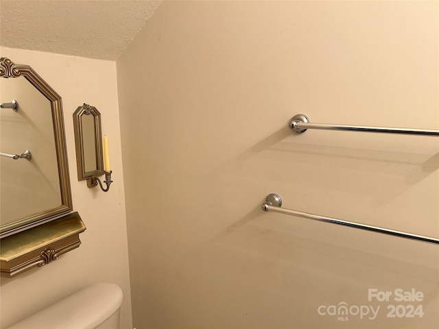 bathroom featuring a textured ceiling and toilet