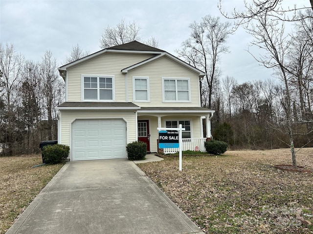 view of front of home featuring a porch and a garage