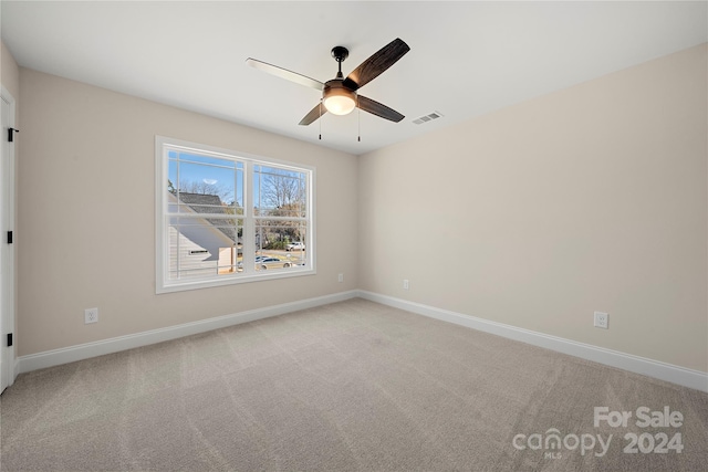 unfurnished room with ceiling fan and light colored carpet