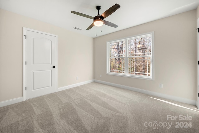 carpeted empty room featuring ceiling fan