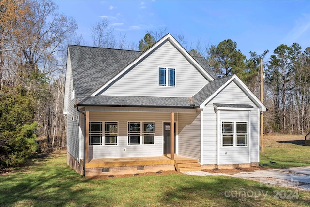 view of front of home featuring covered porch and a front yard